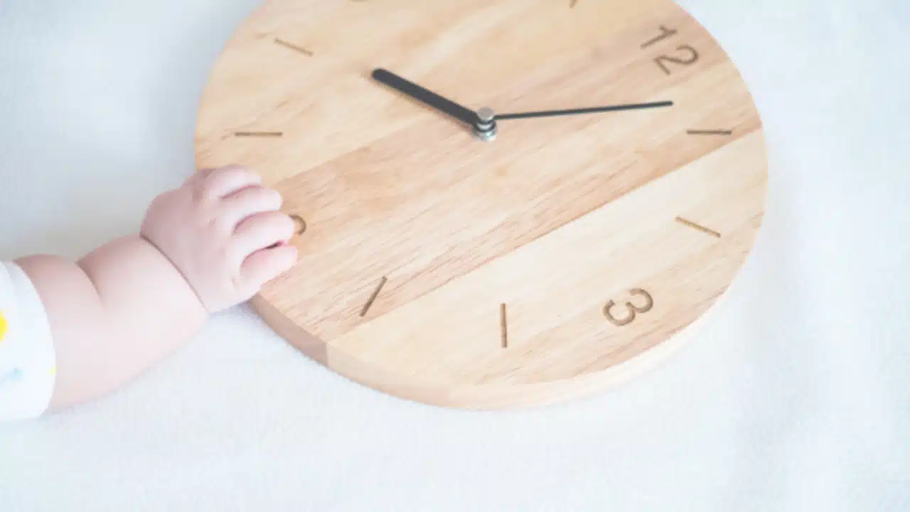 sleep nanny baby touching clock